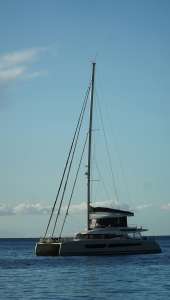 A Catamaran Sailing in Serene Ocean Waters - Monaco Yacht Rentals